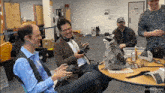 a raccoon sits at a table with a group of men