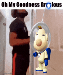 a man standing next to a cartoon character that says oh my goodness groious