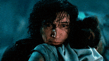 a close up of a man holding a woman with a tear running down his face