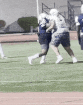 a group of football players are playing a game on a field . one of the players is wearing a number 23 jersey .