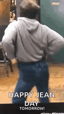 a man is dancing in front of a mirror with the words `` happy jean day tomorrow '' written on it .