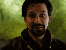 a man with a beard wearing a black jacket