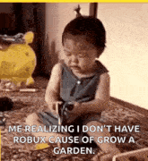 a baby is sitting on the floor cutting a piece of paper with scissors .