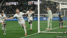 a soccer player celebrates after scoring a goal in front of a banner that says sun