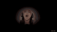 a blurry picture of a girl wearing headphones in the dark