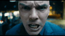 a close up of a man 's face with an angry expression