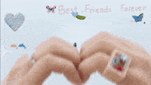 a group of women are making a heart shape with their fingers