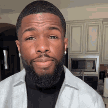 a man with a beard has a nose ring on his nose
