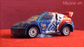 a blue and red toy car with the number 106 on it