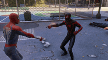 a spider man pointing at another spider man on a basketball court