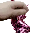 a close up of a person 's hand holding a pink snake .