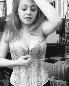 a woman is wearing a corset with a snake print on it .