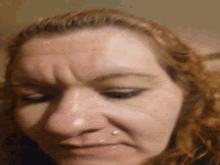 a close up of a woman 's face with a piercing