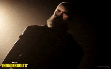 a man with a beard is standing in a dark room with the words thunderbolts on the bottom