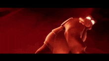 a red light is shining on a person in a dark room