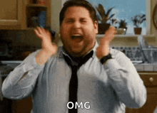 a man in a blue shirt and tie is making a surprised face .