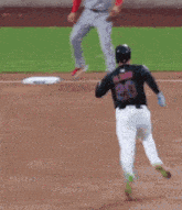a baseball player with the number 20 on his back is running on the field