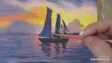 a person is painting a sailboat on a canvas with the words made in animotica on the bottom