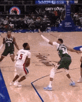 a basketball game is being played on a court with a sign that says grey goose