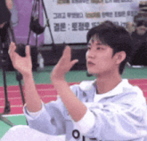 a man in a white shirt with the letter o on it