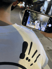 a person is taking a picture with their phone that says ' selfie ' on it