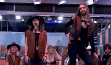 a man and a woman dancing in front of a microphone