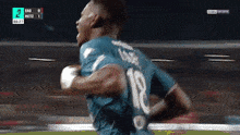 a soccer player wearing a number 18 jersey is running on the field