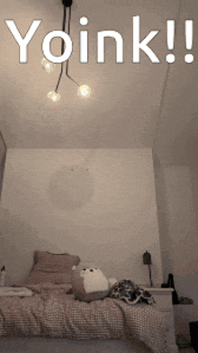 a bed with a stuffed animal on it and the words yoink written above it