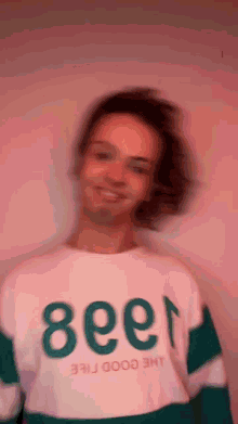 a blurry picture of a man wearing a shirt that says the good free