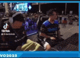 a man is sitting in a chair playing a video game .