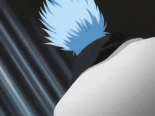 a close up of a person 's back with a blue haircut
