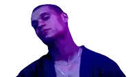 a man is wearing a purple shirt and a necklace