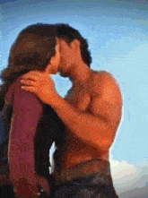 a man and a woman are kissing in a painting