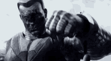a black and white photo of a man in a superhero costume holding a microphone .