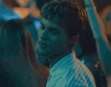 a close up of a man 's face in a crowd