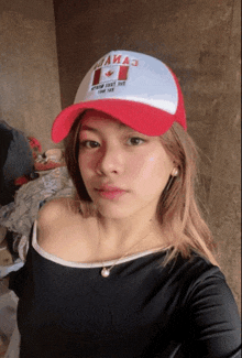 a woman wearing a red and white hat that says canada on it