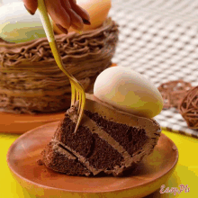 a slice of chocolate cake with a white egg on top is on a wooden plate that says easy ph
