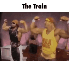 two men are flexing their muscles in front of a crowd and the words the train are above them .