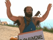 a man in blue overalls is holding a sign that says " cinque "