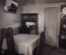 a dining room with a table and chairs and a mirror that says 24 aok