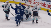 a hockey game is being played in front of an advertisement for scotiabank