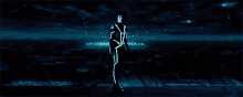 a man in a futuristic suit is standing in a dark room