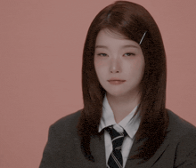 a woman wearing a suit and tie is making a funny face