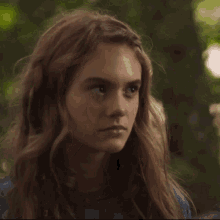 a close up of a girl 's face with long hair