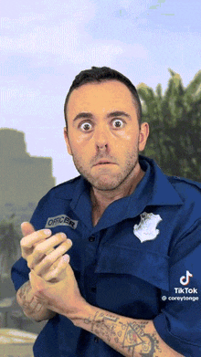 a man in a police uniform with the name officer on his shirt