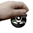 a close up of a person 's hand holding a black object with a star on it .