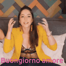a woman in a yellow jacket is sitting on a bed with the words buongiorno amore written on the bottom