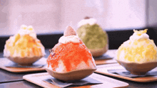 three different flavors of shaved ice on a table