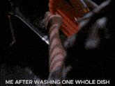 a person is washing a red plate with a sponge and the caption me after washing one whole dish