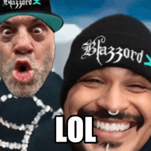 two men are posing for a picture and one of them is wearing a beanie that says blazzard